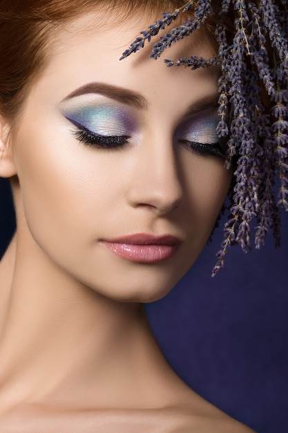 Portrait of young beautiful redhaired woman with floral lavender wreath in her hair