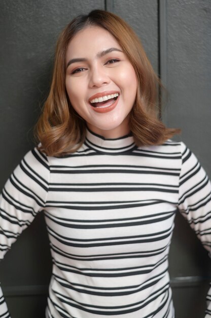 A portrait of young beautiful short hair woman over black background