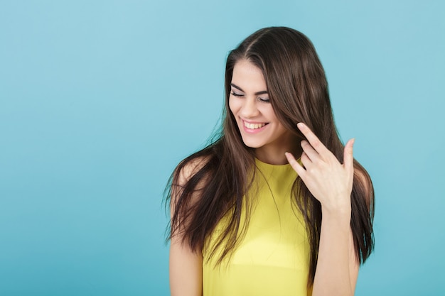 Portrait of young beautiful smiling girl in yellow shirt