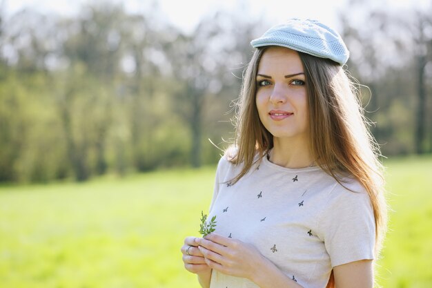 Portrait of the young beautiful smiling woman outdoors