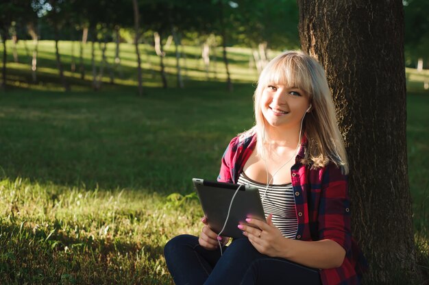 Portrait of young beautiful smiling woman with tablet pc