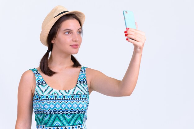 Portrait of young beautiful tourist woman on white