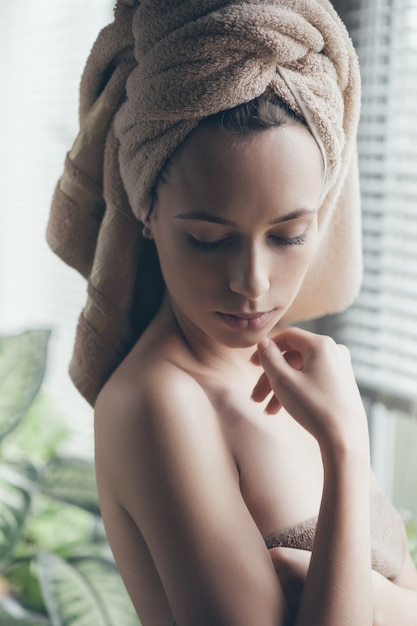 Portrait of young beautiful woman in bathrobe