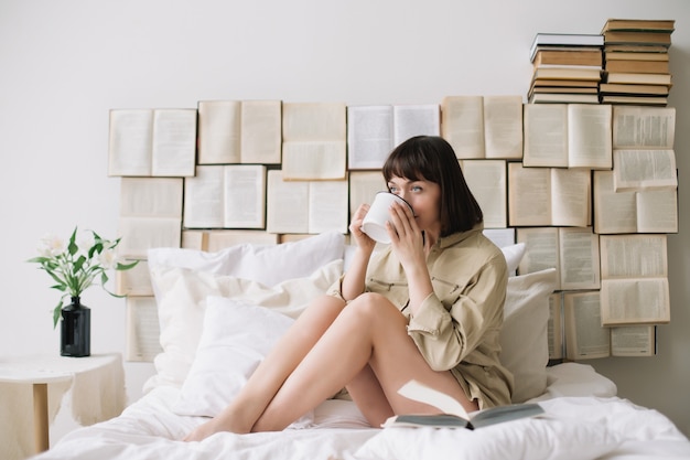 Portrait of a young beautiful woman in bed at home