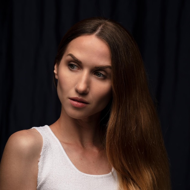 portrait of a young beautiful woman on a dark background