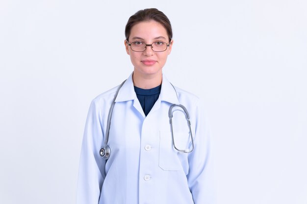 Portrait of young beautiful woman doctor with eyeglasses on white