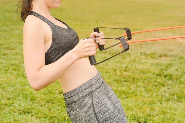 Portrait of young beautiful woman doing exercise at park