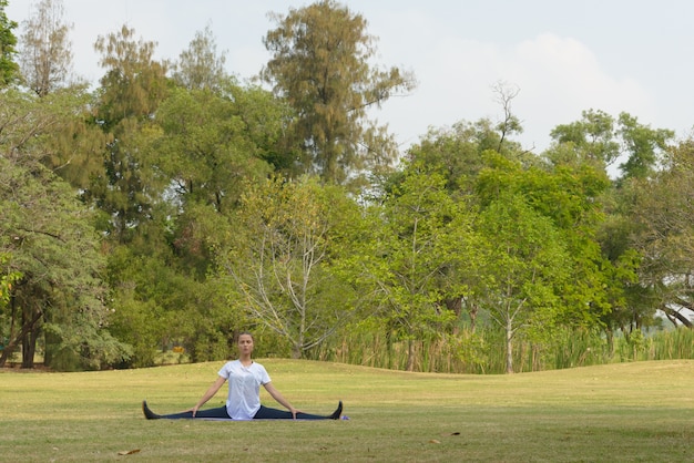 Portrait of young beautiful woman exercising at the park outdoors