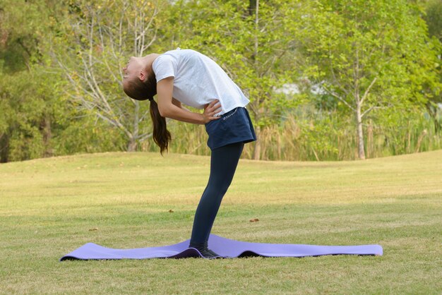 Portrait of young beautiful woman exercising at the park outdoors