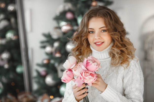 portrait of young beautiful woman holding a bouquet