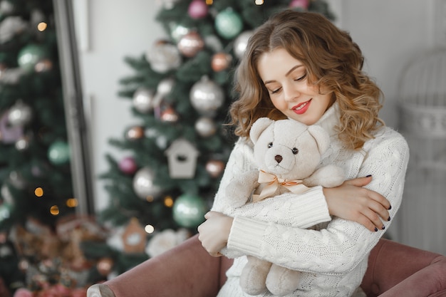 portrait of young beautiful woman holding a teddy bear