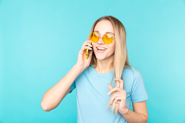 Portrait of young beautiful woman isolated on blue in t-shirt on blue