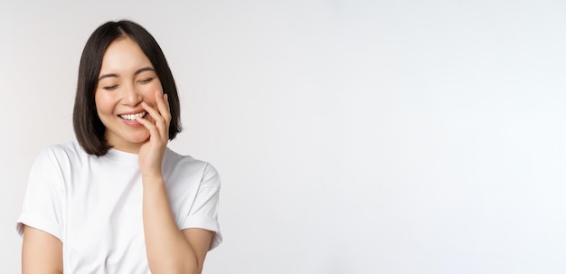 Portrait of young beautiful woman korean girl laughing and smiling looking coquettish standing again