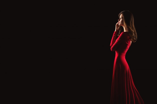 Portrait of young beautiful woman in red dress