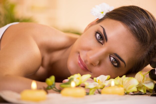 Portrait of Young beautiful woman relaxing and enjoying at the spa center.