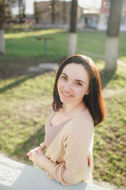 Portrait of a young beautiful woman on the street in the park