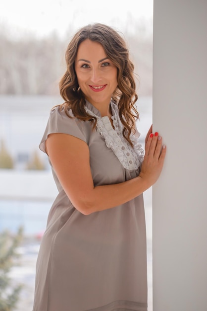 portrait of a young beautiful woman in a stylish modern interior near the window