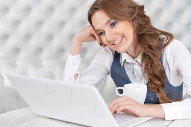 Portrait of a young beautiful woman using laptop