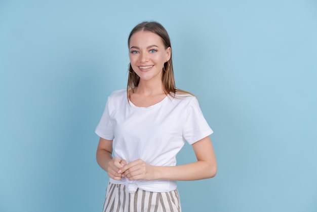 Portrait young beautiful woman in white tshirt with crossed arms confident