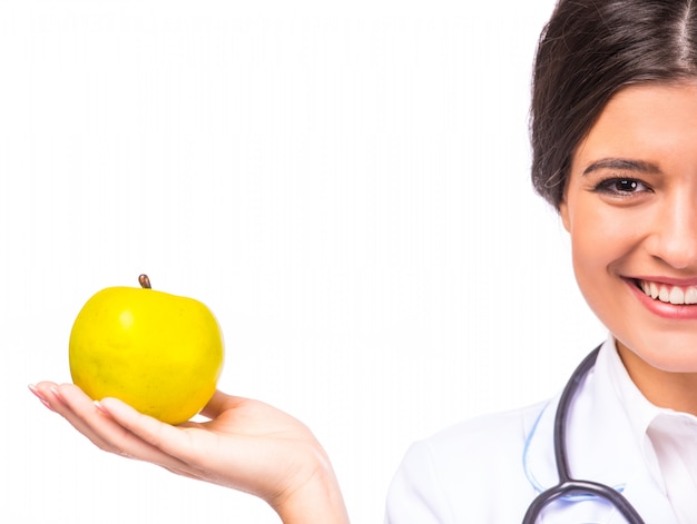 Portrait of a young beautiful woman with apple.