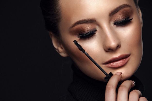 Portrait of young beautiful woman with evening make up