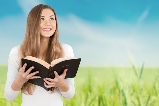 Portrait of young beautiful woman with open book