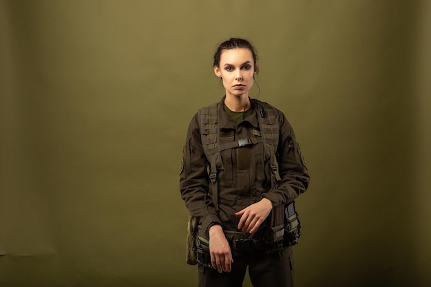 Portrait of young beautiful woman with serious expression on the face of military soldier