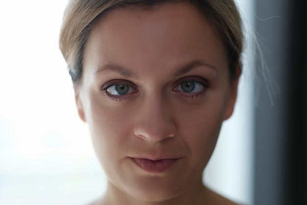 Portrait of young beautiful woman with squint eyes