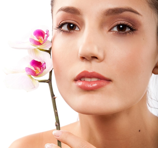 portrait of young beautiful woman with white orchid