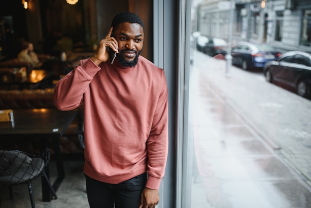 Portrait young black businessman talking on mobile phone