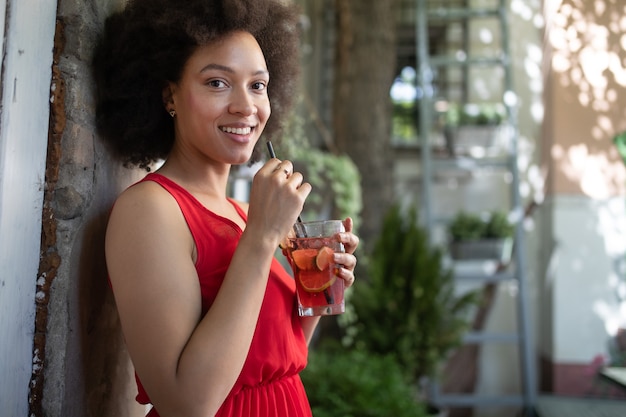 Portrait of a young black woman, model of fashion wearing dress with afro hairstyle