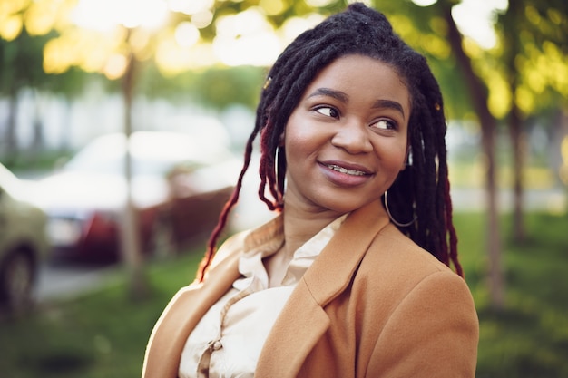 Portrait of a young black woman standing in a street