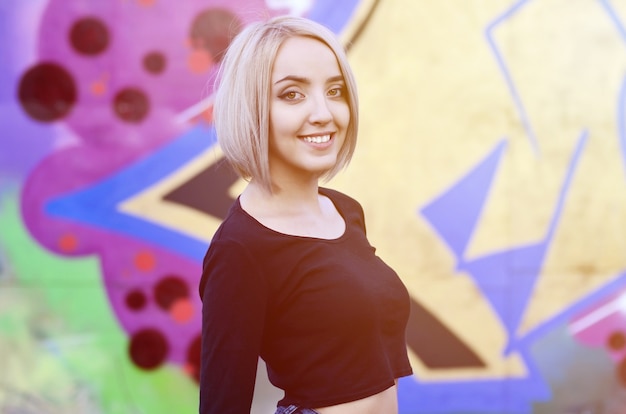 Portrait of a young blond girl with short hair 