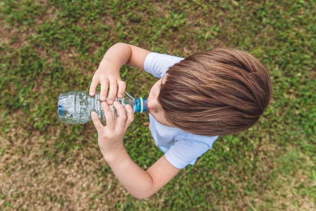 portrait young boy drinking water