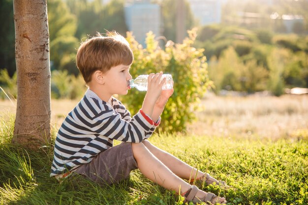 portrait young boy drinking water