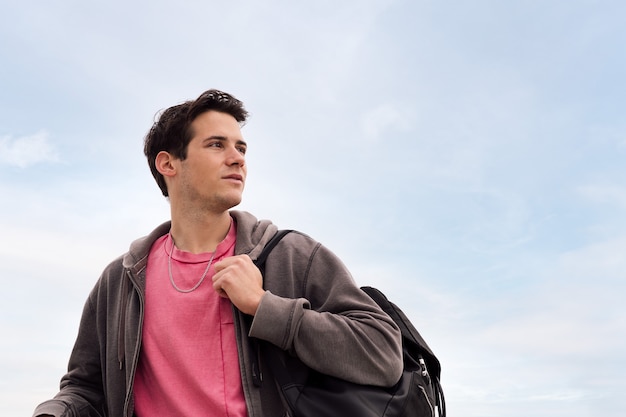 Portrait of a young boy in front of the blue sky concept of youth and adolescent lifestyle