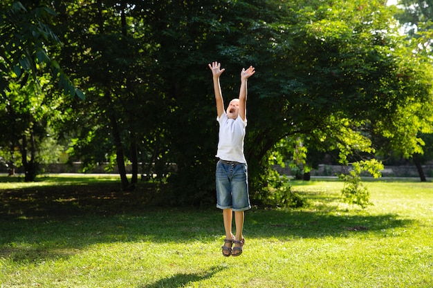 portrait young boy jumping