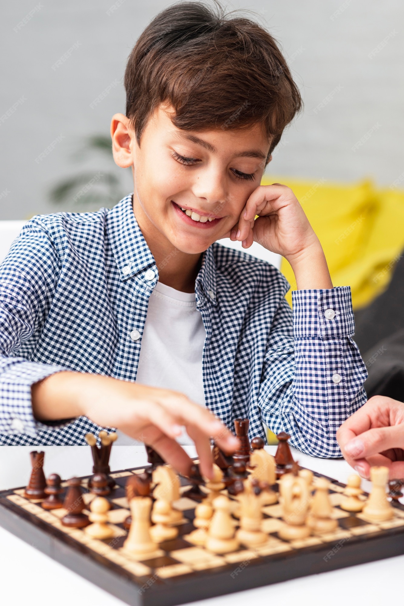 Premium Photo  Portrait of child during chess game boy plays chess and  thinks intently about the next move isolation on white background