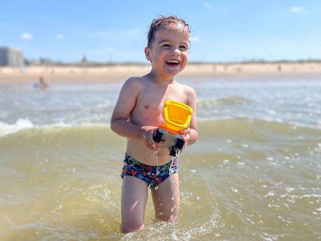 Portrait of young boy playing in sea