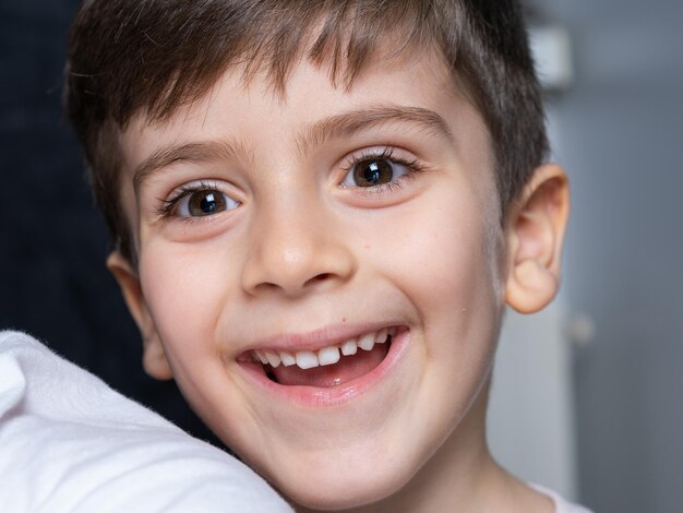 Portrait of an young boy sitting on chair