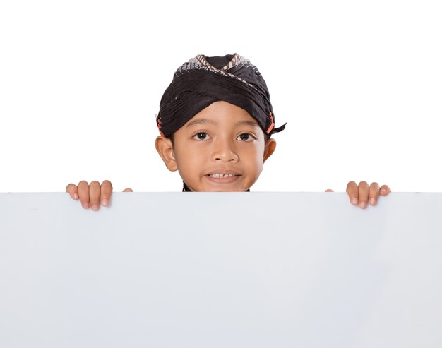 Portrait of a young boy wearing traditional Javanese clothes