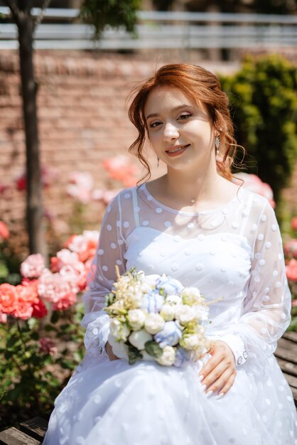 Portrait of a young bride girl in a light dress in an urban environment