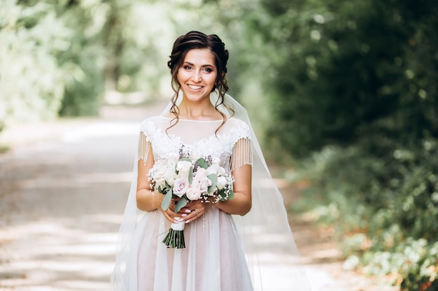 Portrait of a young bride posing in nature