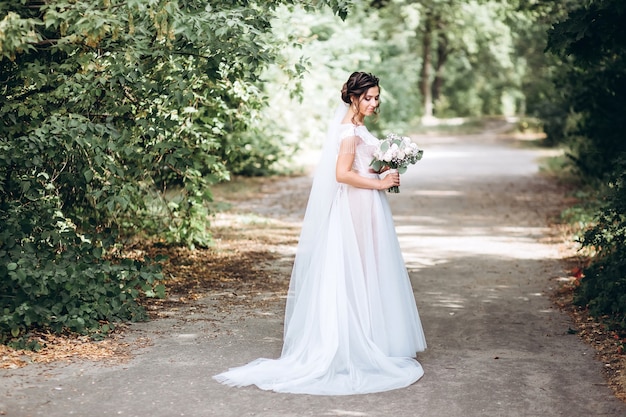 Portrait of a young bride posing in nature