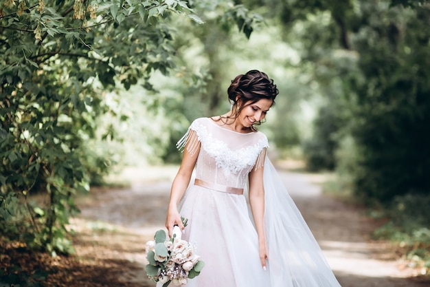 Portrait of a young bride posing in nature