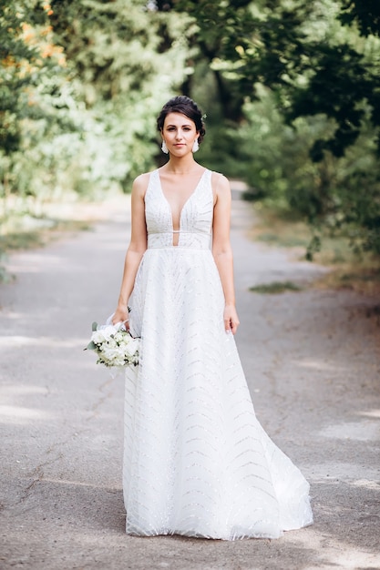 Portrait of a young bride posing in nature