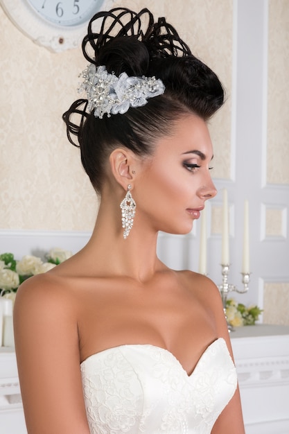 Portrait of young brunette bride with beautiful wedding coiffure