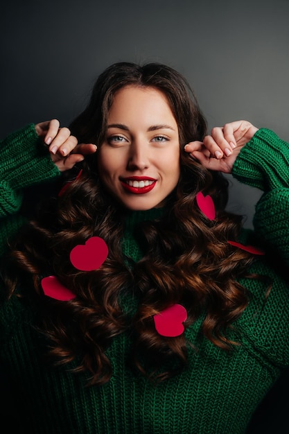 portrait of a young brunette of European appearance with curls and hearts in her hair