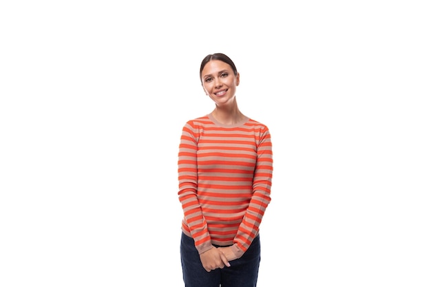 Portrait young brunette european slim woman dressed in casual orange sweater isolated on white