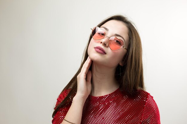 Portrait of a young brunette with long hair in the studio